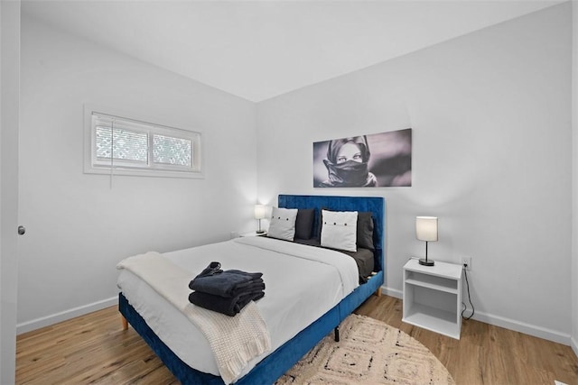 bedroom with wood finished floors and baseboards