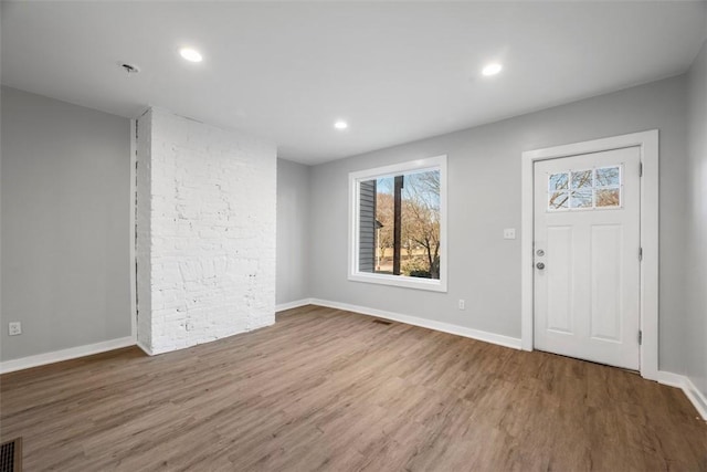 foyer with recessed lighting, baseboards, and wood finished floors