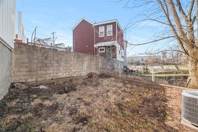 view of property exterior featuring central AC unit and fence