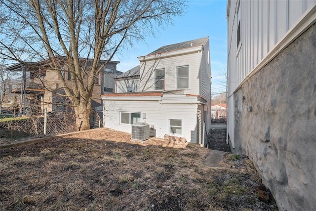 rear view of house featuring central AC