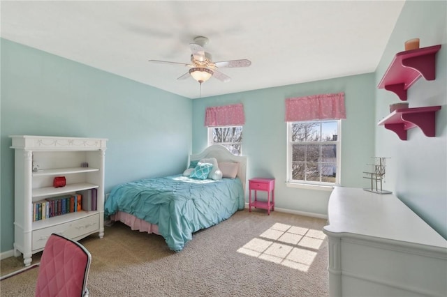 carpeted bedroom with baseboards and a ceiling fan