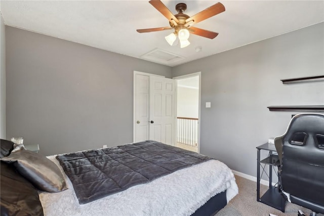 carpeted bedroom with attic access, baseboards, ceiling fan, and a closet