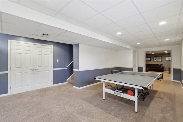 rec room featuring a paneled ceiling, carpet flooring, visible vents, and baseboards