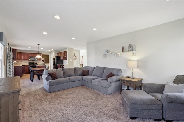 living room featuring light carpet and recessed lighting