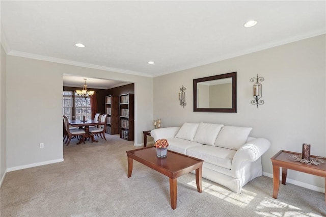 living area featuring baseboards, ornamental molding, and a chandelier