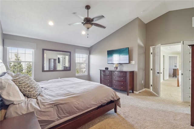 bedroom with lofted ceiling, multiple windows, baseboards, and light carpet