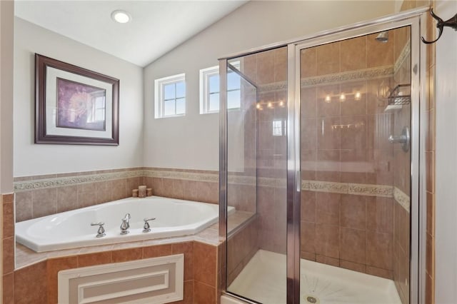 full bathroom with lofted ceiling, a garden tub, and a stall shower