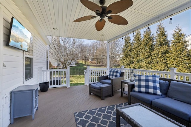 wooden deck featuring an outdoor hangout area and a ceiling fan