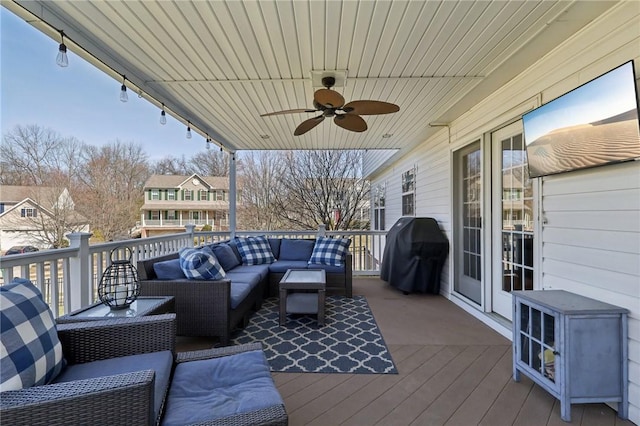 wooden deck featuring a ceiling fan, grilling area, and an outdoor hangout area