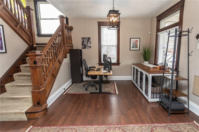 office featuring a notable chandelier, baseboards, and wood finished floors