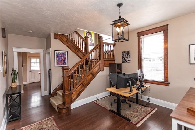 office area featuring a chandelier, a textured ceiling, wood finished floors, and baseboards