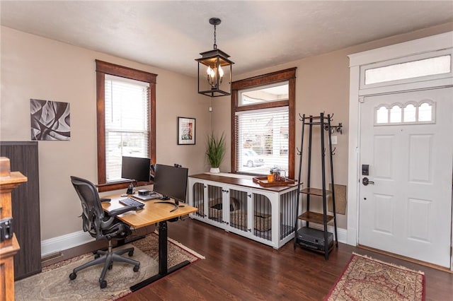 home office featuring a chandelier, wood finished floors, and baseboards