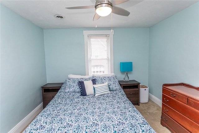 bedroom featuring light carpet, baseboards, visible vents, and a ceiling fan