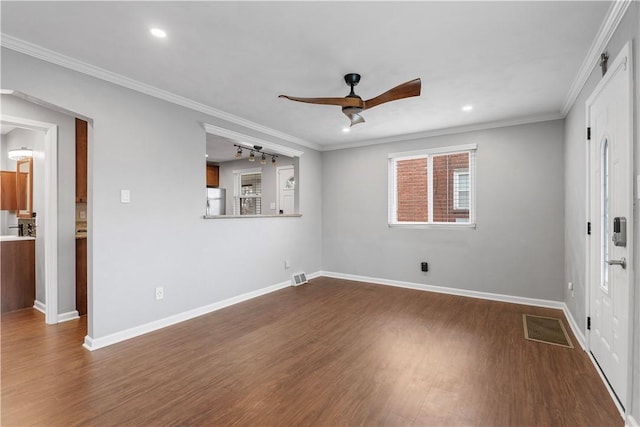 interior space featuring a ceiling fan, baseboards, visible vents, dark wood finished floors, and crown molding