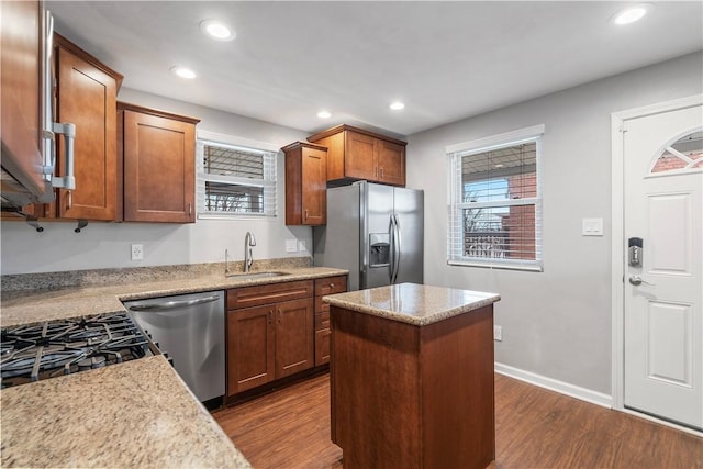 kitchen featuring dark wood-style flooring, dishwasher, refrigerator with ice dispenser, and a sink