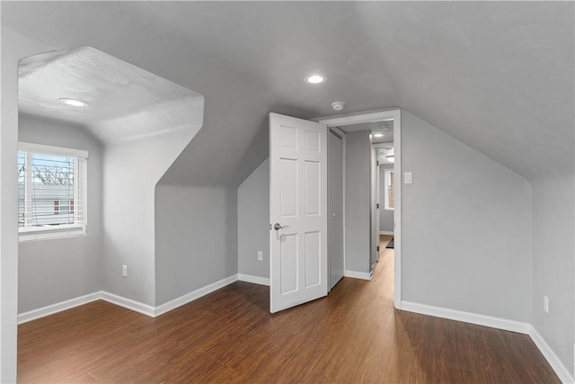 additional living space with vaulted ceiling, recessed lighting, wood finished floors, and baseboards