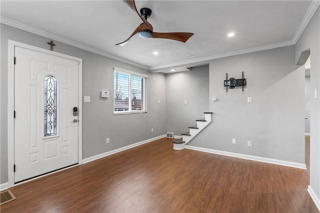 entryway with wood finished floors, visible vents, baseboards, stairs, and ornamental molding