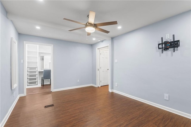 empty room featuring ceiling fan, recessed lighting, visible vents, baseboards, and dark wood-style floors