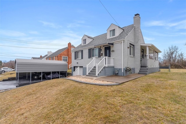 back of property featuring a carport, a yard, brick siding, and a chimney