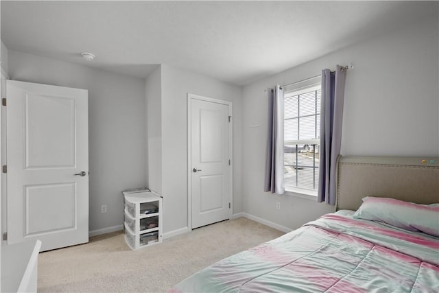 bedroom featuring baseboards and carpet flooring