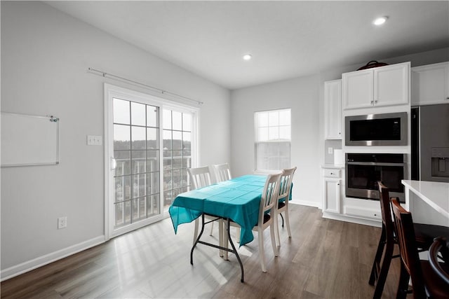 dining space with recessed lighting, dark wood finished floors, and baseboards