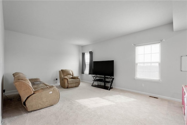 sitting room featuring carpet floors, visible vents, and baseboards