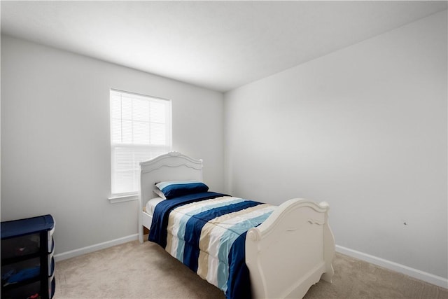 bedroom featuring carpet floors and baseboards