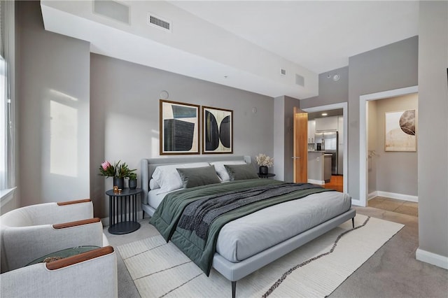 bedroom with light colored carpet, stainless steel fridge with ice dispenser, visible vents, and baseboards