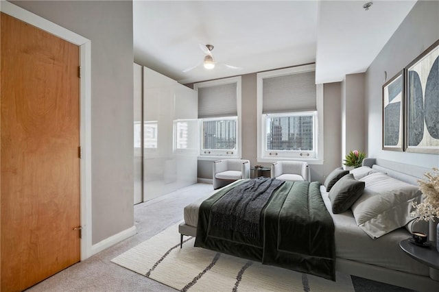 carpeted bedroom featuring ceiling fan and baseboards