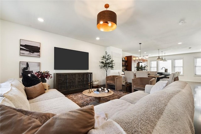 living room featuring recessed lighting, baseboards, and wood finished floors