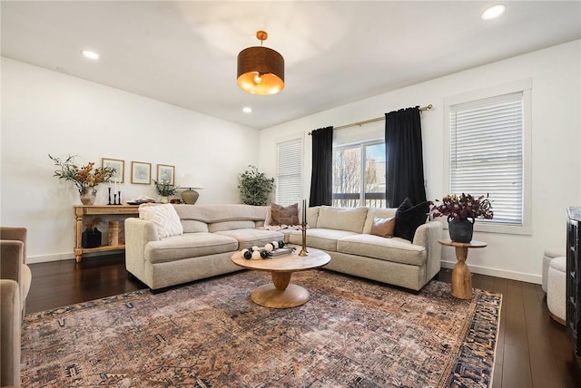 living area with recessed lighting, dark wood finished floors, and baseboards