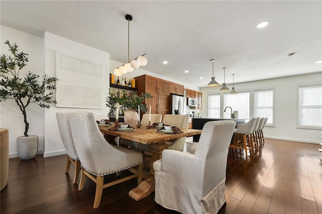 dining space with recessed lighting, dark wood-style flooring, and baseboards