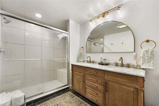 full bath featuring tile patterned flooring, a sink, a shower stall, and double vanity