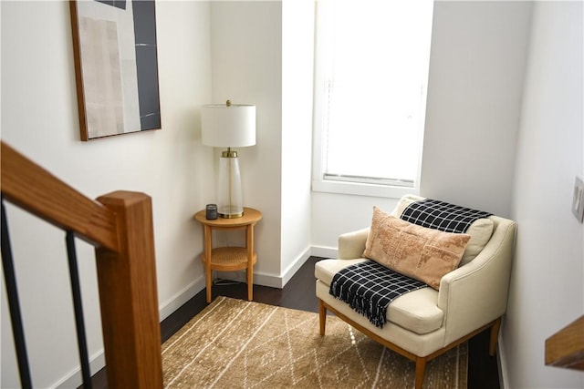 living area with baseboards and wood finished floors