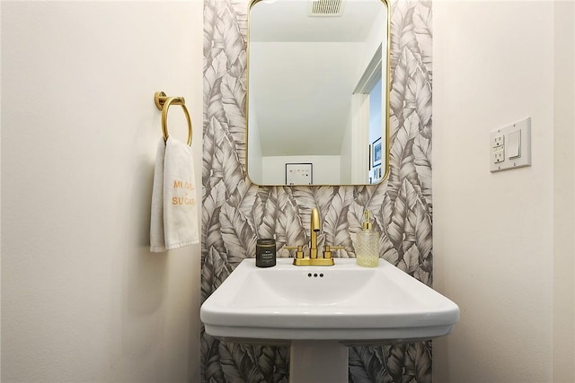 bathroom featuring visible vents and a sink