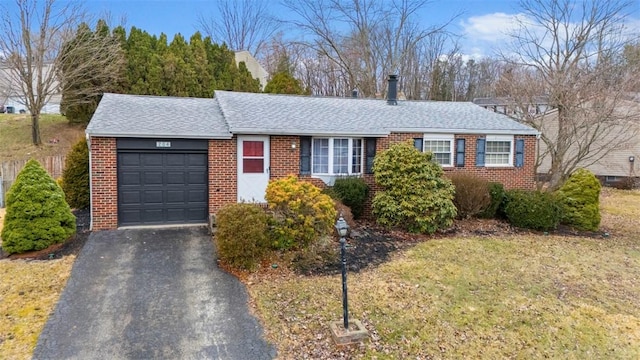 single story home featuring aphalt driveway, brick siding, a garage, and a shingled roof