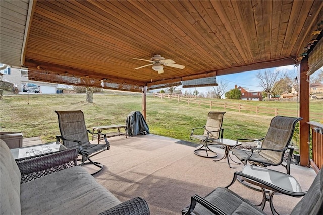 view of patio featuring ceiling fan and fence