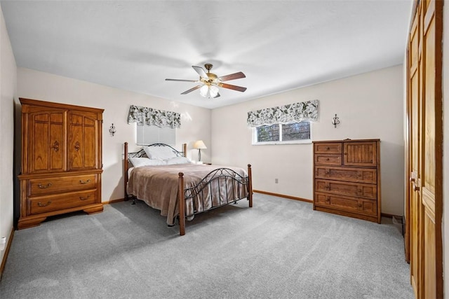 bedroom featuring ceiling fan, baseboards, and light colored carpet