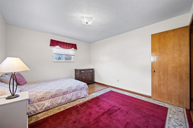 bedroom featuring wood finished floors and baseboards