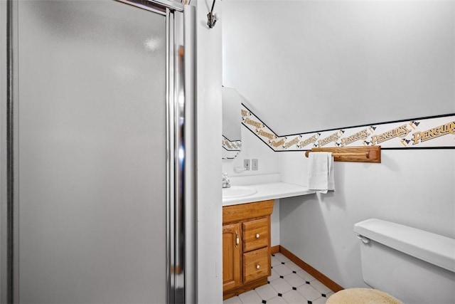 bathroom with toilet, vanity, baseboards, a shower stall, and tile patterned floors