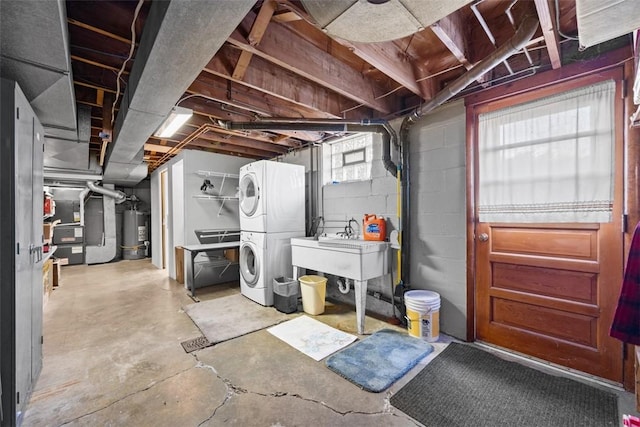 basement with a sink, stacked washer and dryer, and gas water heater