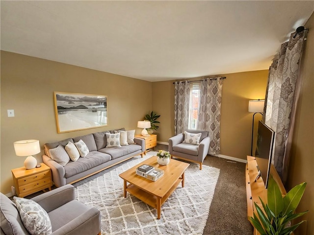 living area featuring carpet and baseboards