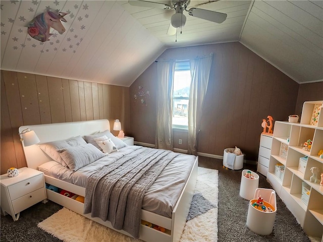 bedroom with lofted ceiling, ceiling fan, and wood walls