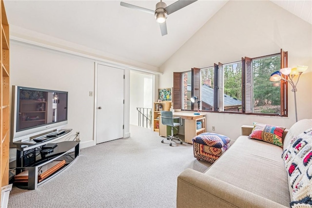 carpeted living area with a ceiling fan and high vaulted ceiling