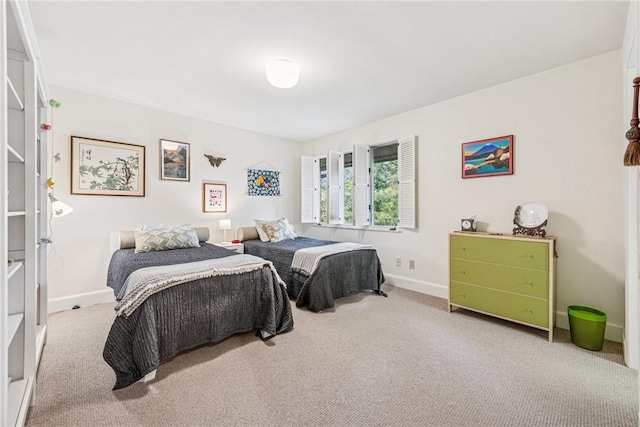 bedroom featuring carpet flooring and baseboards