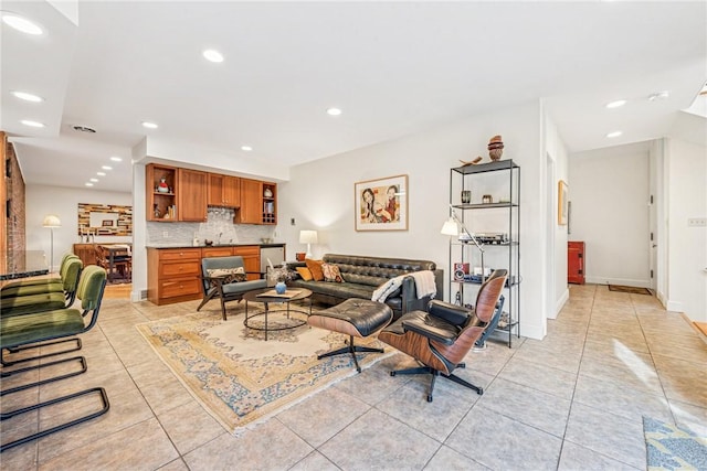 living room with light tile patterned floors, visible vents, baseboards, and recessed lighting