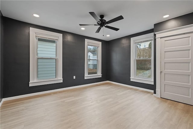 spare room with a ceiling fan, recessed lighting, baseboards, and wood finished floors