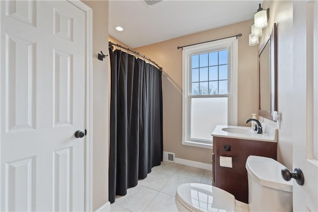 full bathroom featuring toilet, visible vents, baseboards, vanity, and tile patterned floors