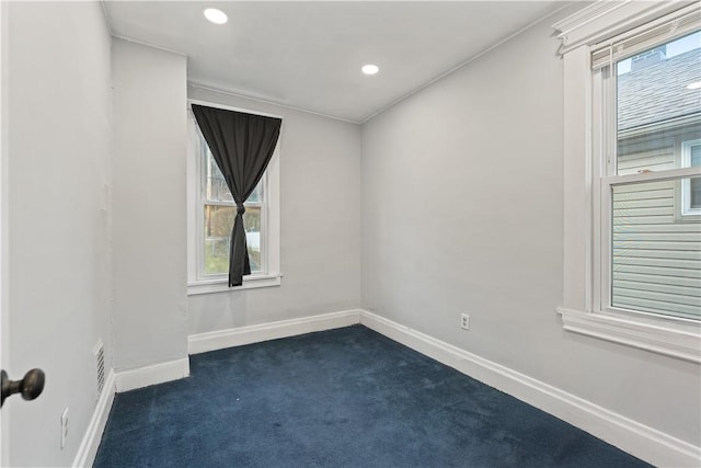 unfurnished room featuring recessed lighting, dark carpet, and baseboards