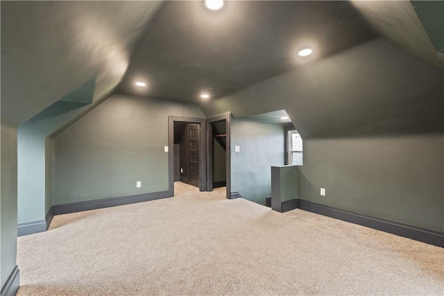 additional living space featuring vaulted ceiling, baseboards, carpet flooring, and recessed lighting